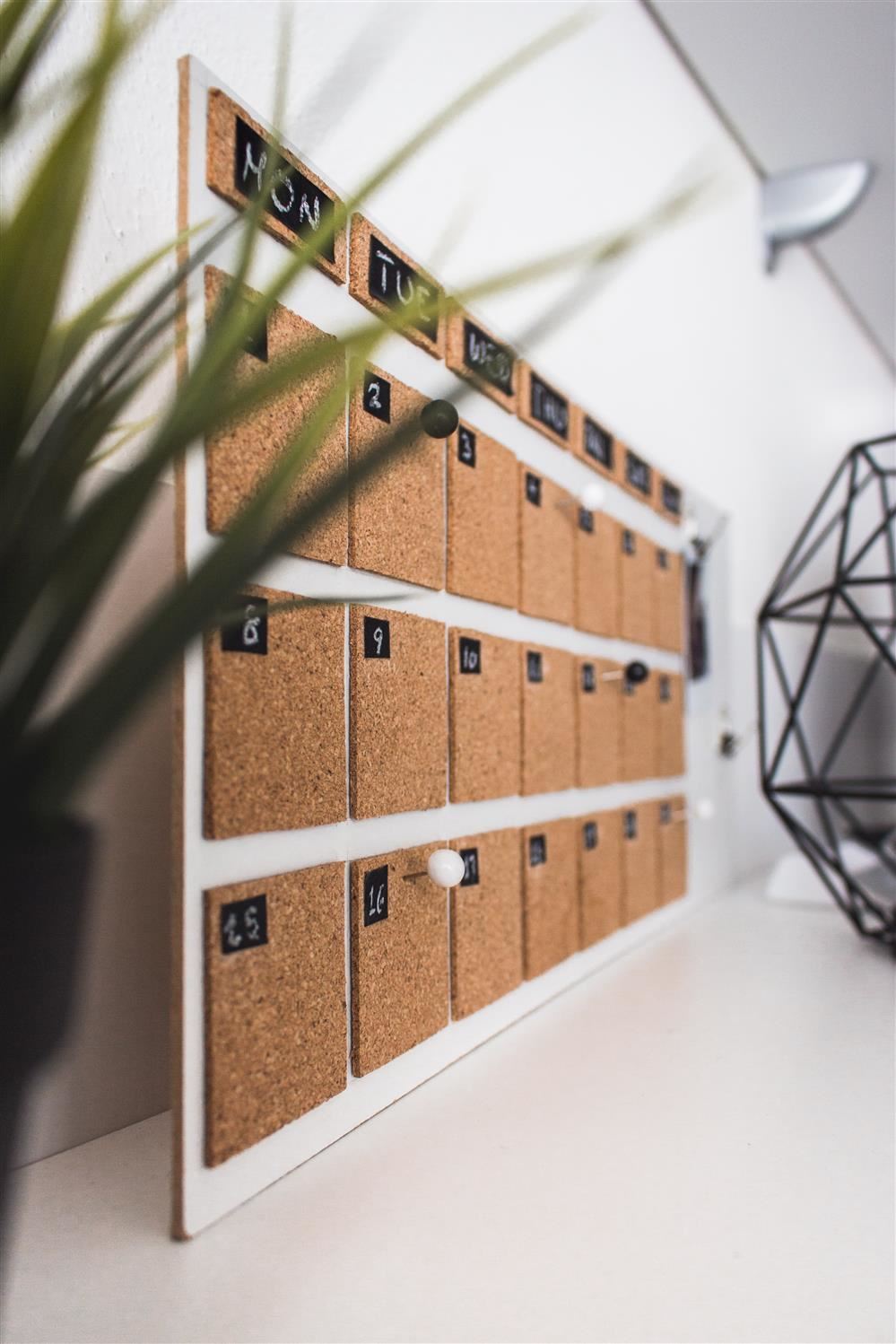  A picture of a calendar that has little corkboards shown at a side view.